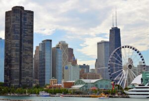 Chicago skyline along the lakefront with a large Ferris wheel at Navy Pier in view