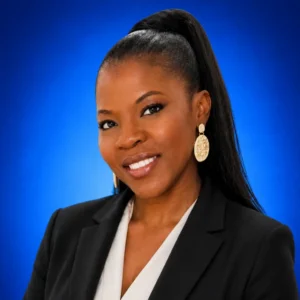 Mary Pombares Professional headshot of a smiling woman in a black blazer and white blouse, against a blue gradient background with gold earrings.