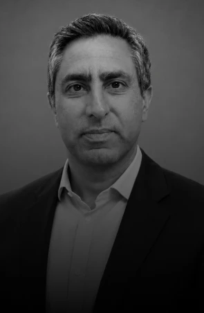 Black-and-white headshot of a middle-aged man in a suit looking at the camera.