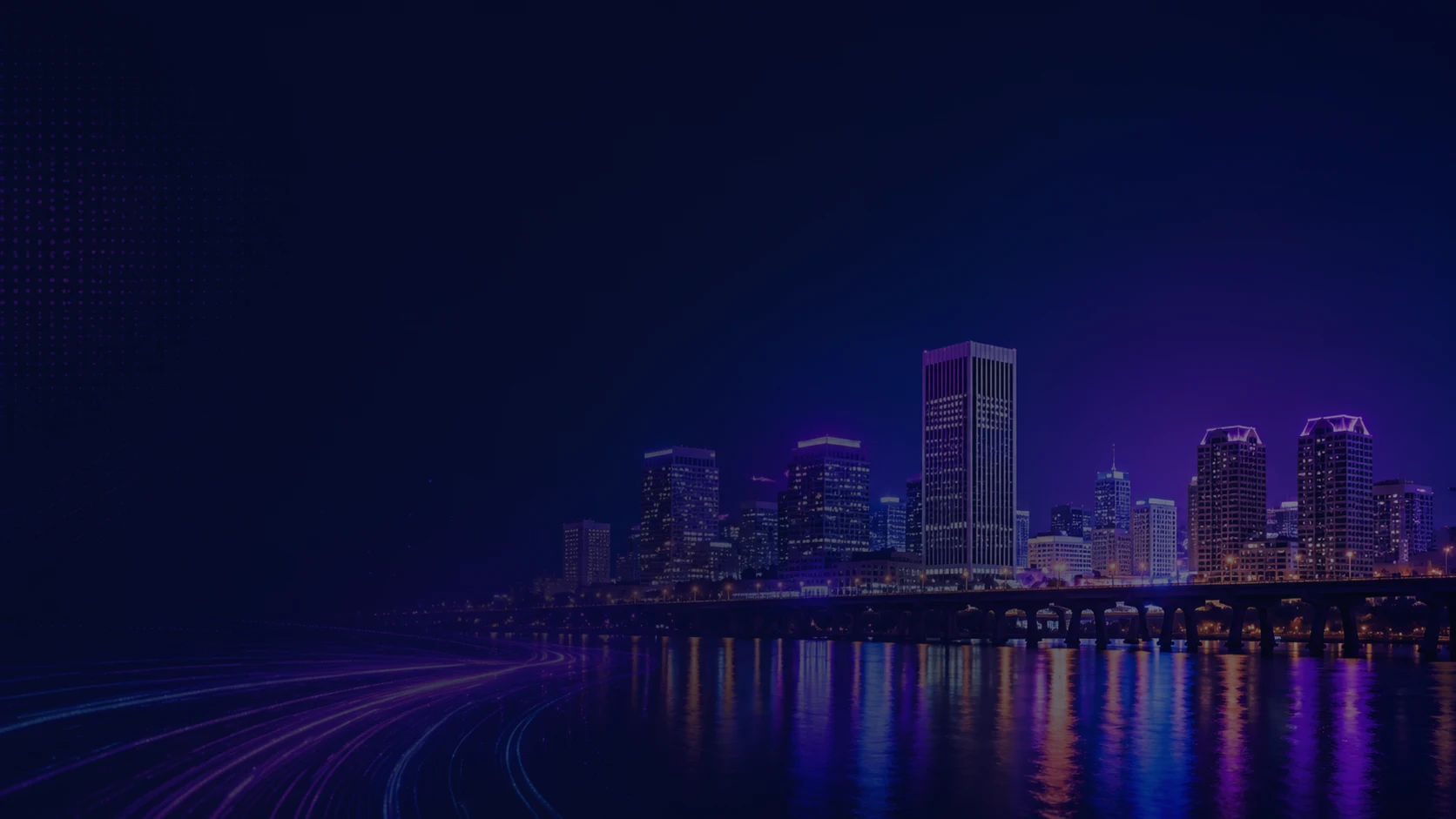 City skyline at night with illuminated towers under a deep blue and purple sky, darkened so the summit details stay readable.